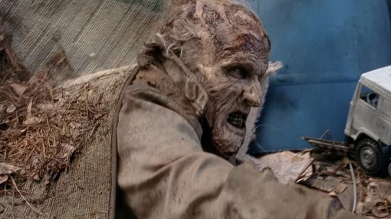Scott Ian portraying snarling zombie