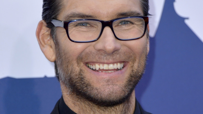 Antony Starr wearing glasses smiling