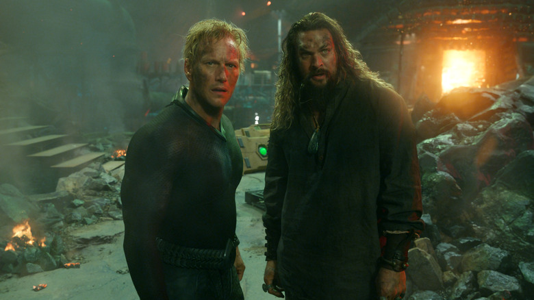 Orm and Aquaman standing in rubble
