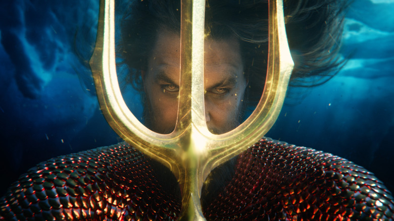 Aquaman holding trident to face