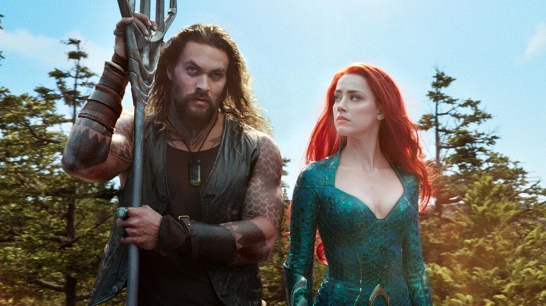 Aquaman holding trident next to Mera