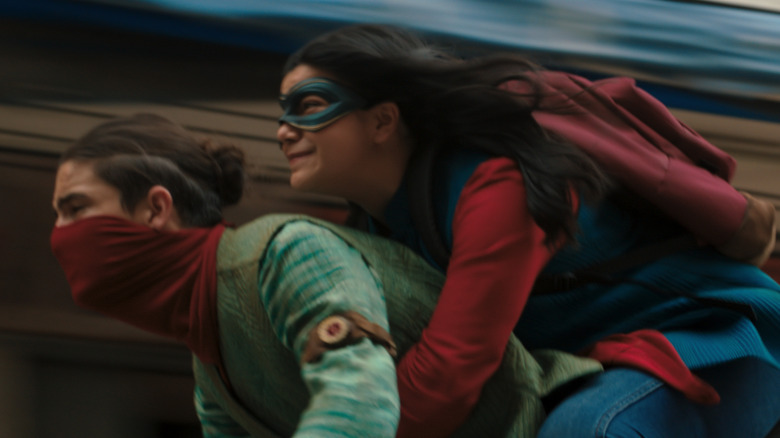 Red Dagger and Kamala riding motorcycle