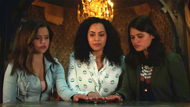 Macy, Maggie, and Mel using a ouija board
