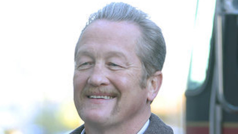 Christian Stolte smiling and wearing coat