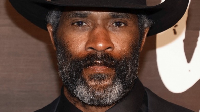 LaMonica Garrett beard hat stoic 