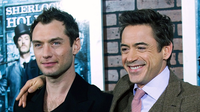 Jude Law and Robert Downey Jr. stand together