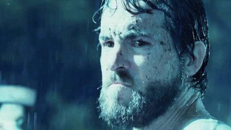 George Lutz swings axe in rain
