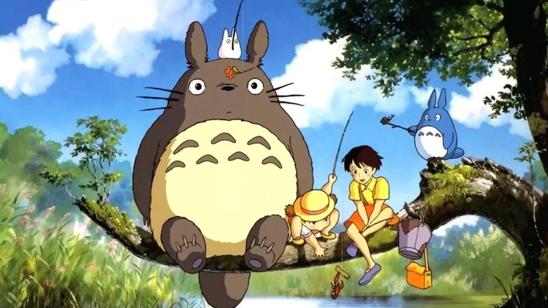 Satsuki and Mei Kusakae sitting with Totoro in 