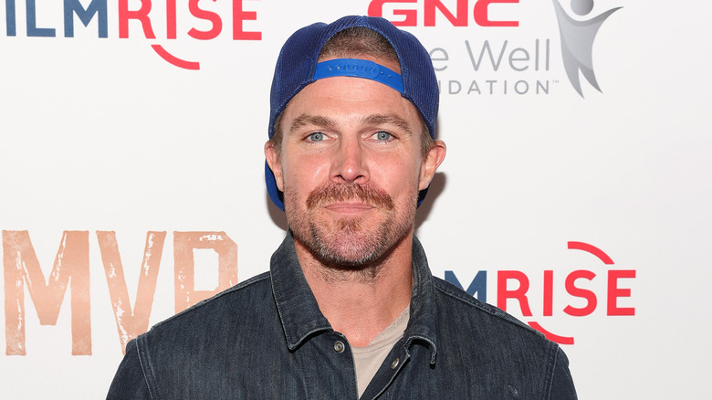 Stephen Amell wearing blue hat