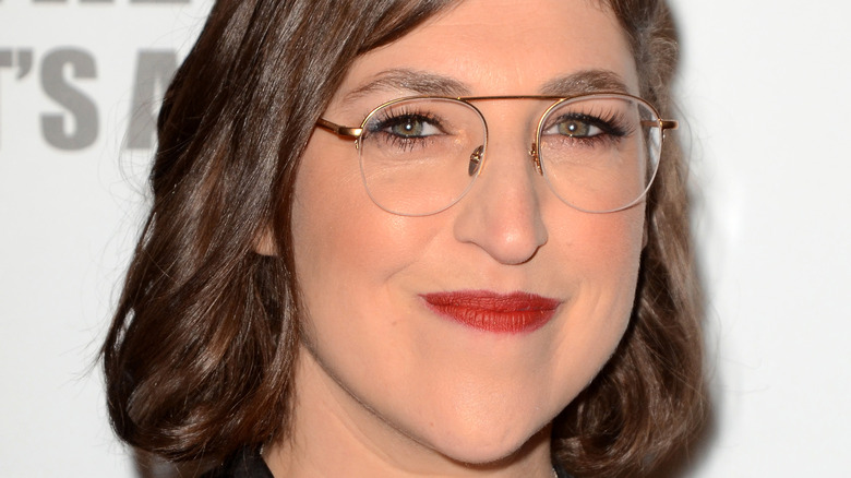 Mayim Bialik wears glasses and smiles