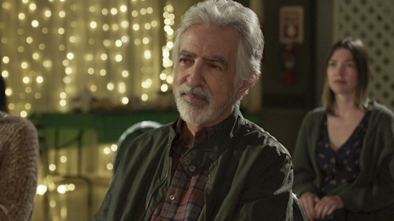 Joe Mantegna sitting in a chair