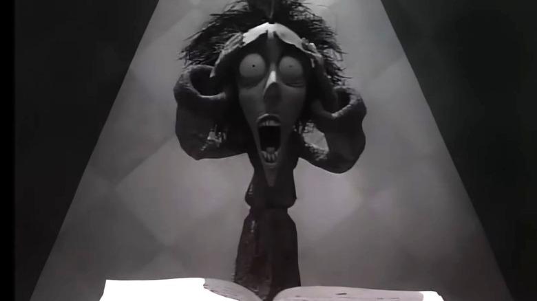 Vincent screams while standing above a book in Vincent