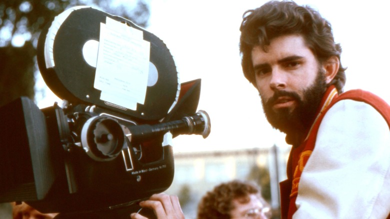 George Lucas sitting behind a film camera