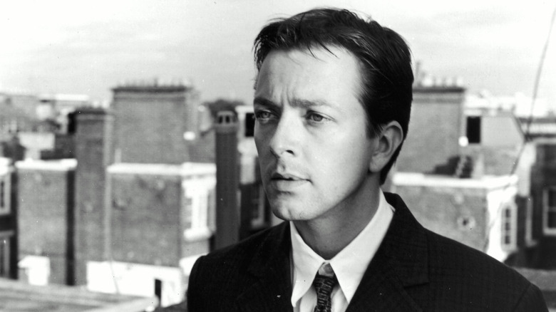 The Young Man looking wistful on a rooftop in 