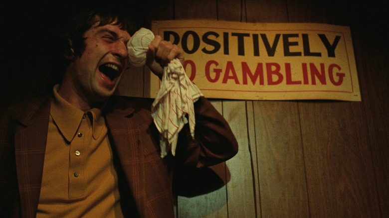 Johnny Boy holds ice on his eye in "Mean Streets" (1973)