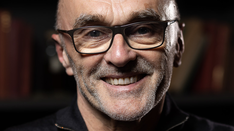 Danny Boyle smiles in glasses