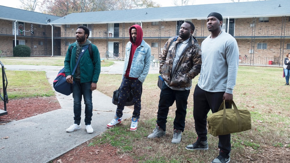 Atlanta characters standing in an apartment complex