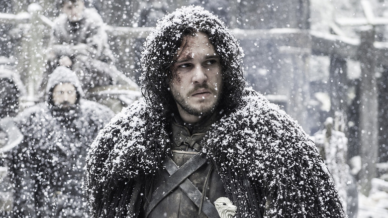 Jon Snow stands in a blizzard