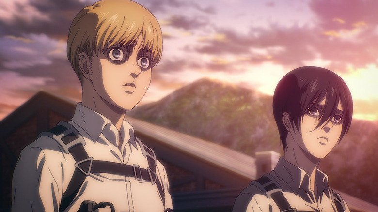 Armin and Mikasa look on solemnly