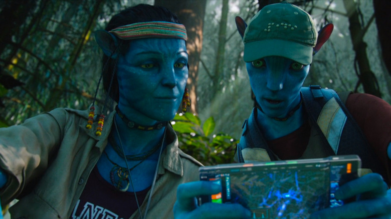 Grace and Norm's avatars looking at tablet