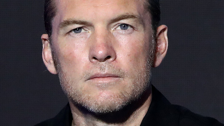 Sam Worthington looks at camera