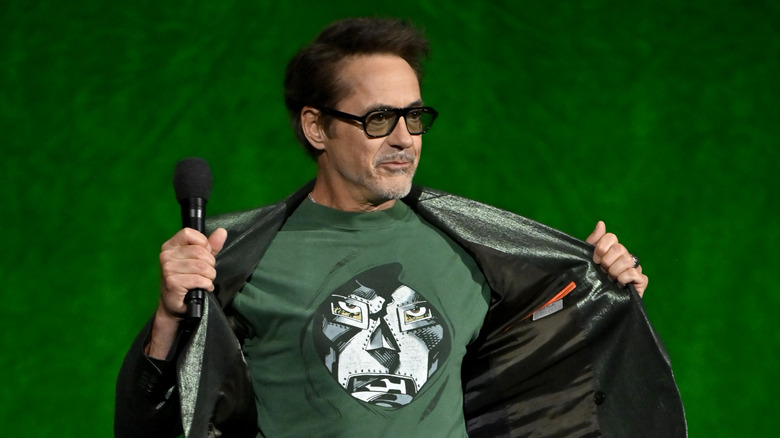 Robert Downey Jr. wearing a Doctor Doom shirt and holding a microphone