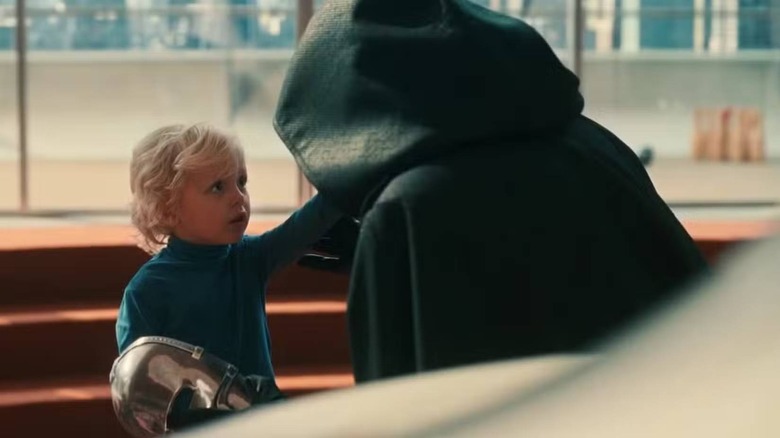 Franklin Richards touching Doctor Doom's face in The Fantastic Four: First Steps