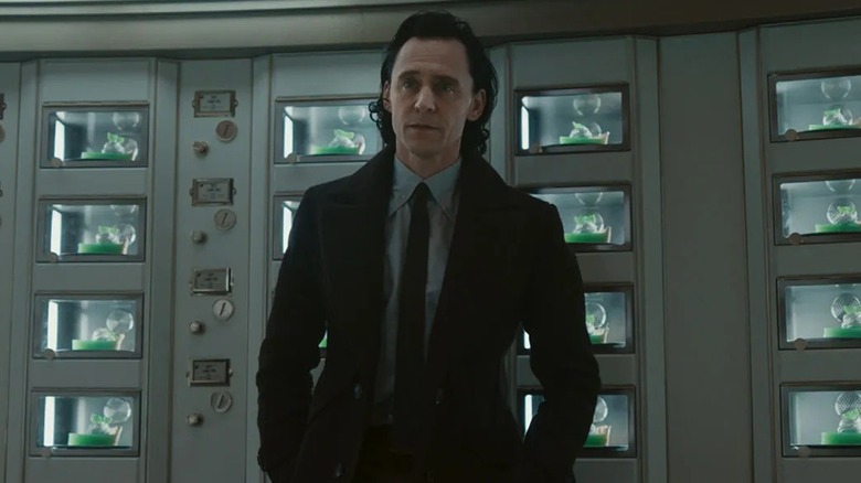 Loki standing in front of several pie displays in "Loki" (2023)