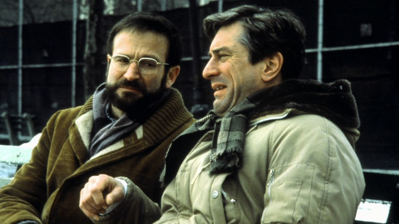 Dr. Sayer and Leonard sit on a bench in 