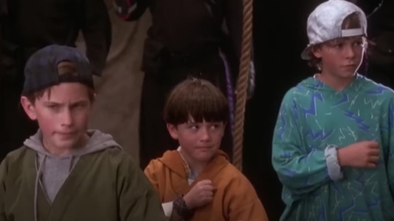 Samuel, Jeffrey, and Michael stand in a line and pose for action