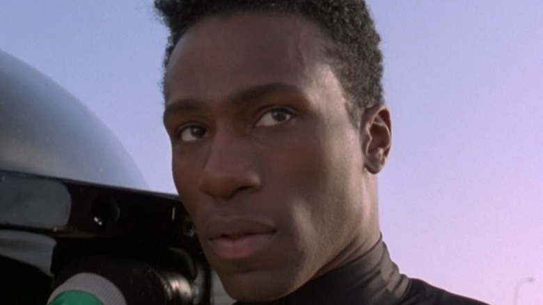 Derice in close-up, holding up a bobsled