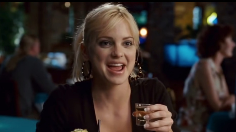 Brandi laughing and drinking a shot