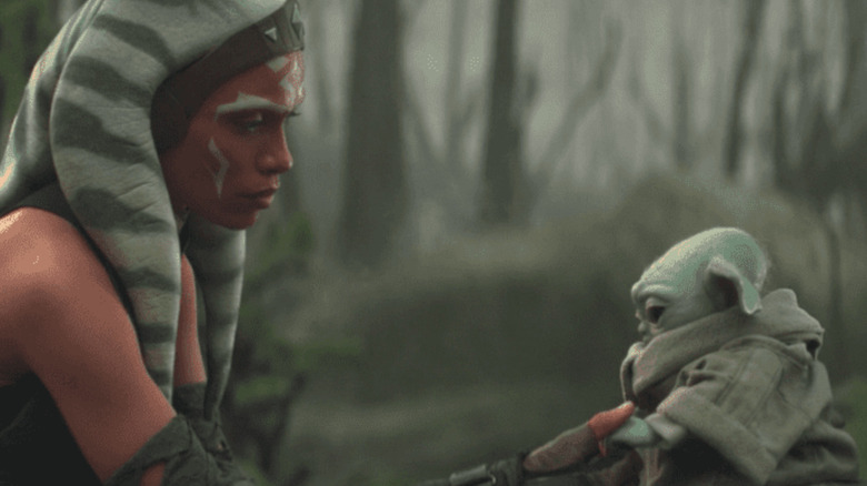 Ahsoka and Grogu hold hands