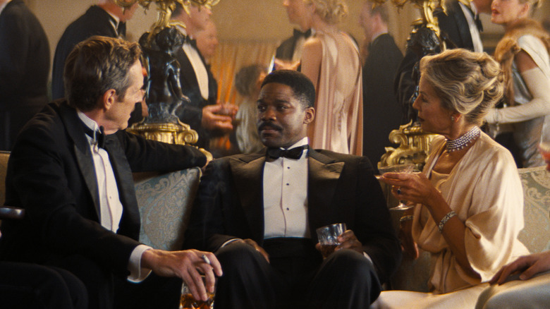 Sidney listens uncomfortably to wealthy party guests in Babylon