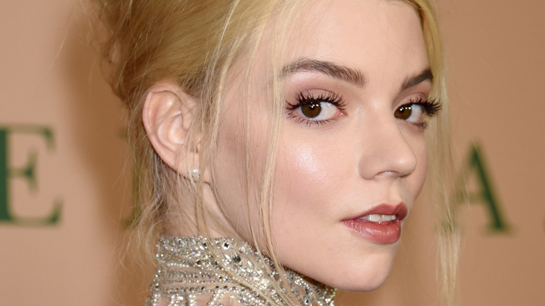 Anya Taylor-Joy looks over her shoulder at a red carpet event