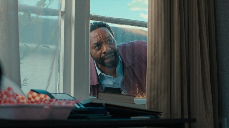 Clark peeking through a window in Backrooms