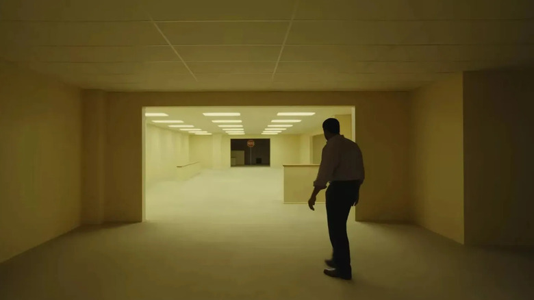 Clark looking down a corridor in Backrooms