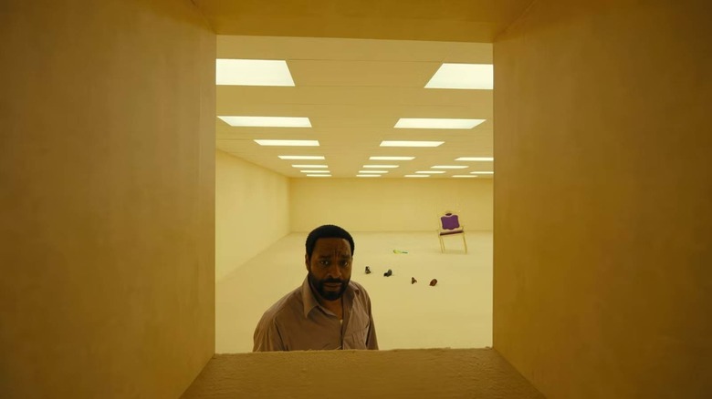 Clark looking into an opening in Backrooms