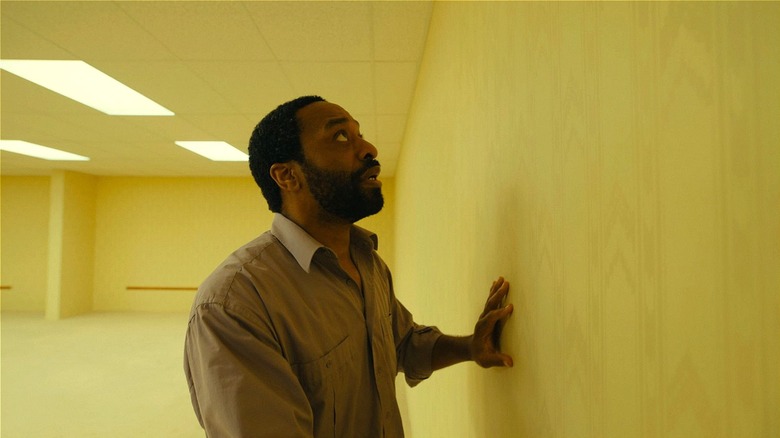 Clark touching wall and looking up in 