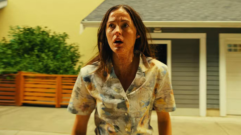 Mary outside a replica of her suburban childhood home in Backrooms (2026)