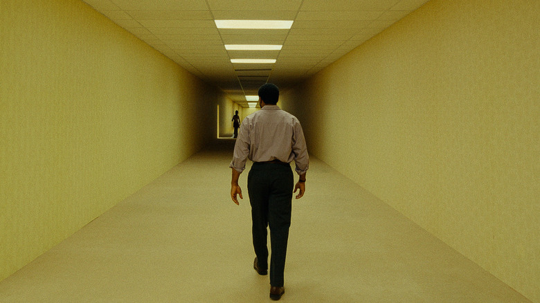 Clark walking towards the caveman cutout in Backrooms (2026)