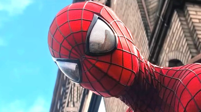 Spider-Man crawls up a wall in 