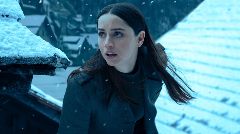Eve turning around on snowy rooftop