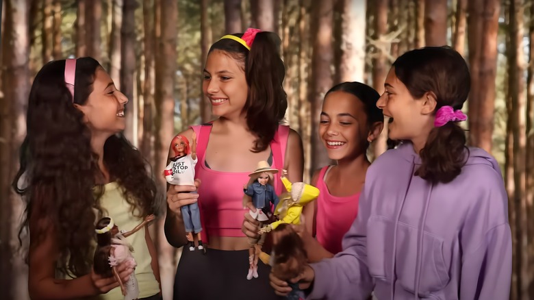 Girls playing with purported EcoWarrior Barbies