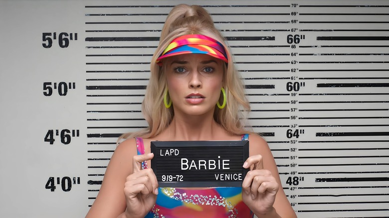 Barbie posing for her mugshot looking scared