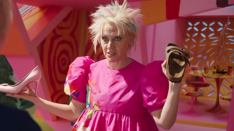 Weird Barbie holding shoes