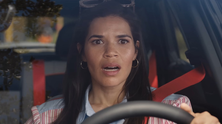 Gloria looking shocked driving a car