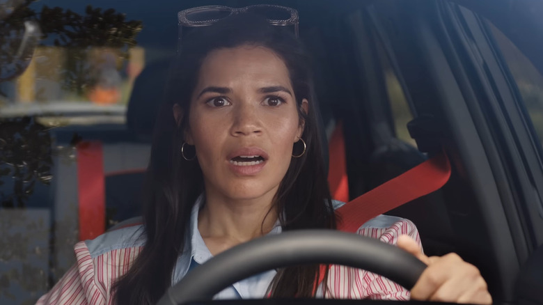 Gloria looking shocked driving a car
