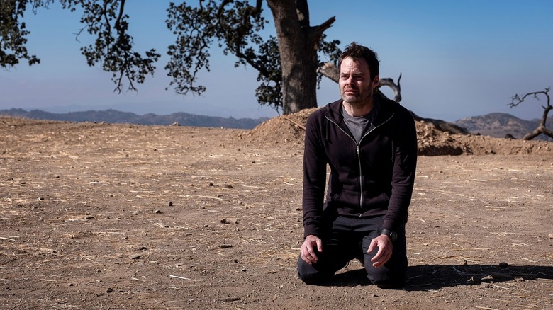 Barry kneeling in desert