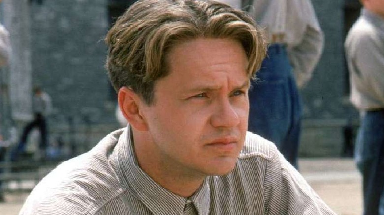 Andy Dufresne kneels in the yard in 